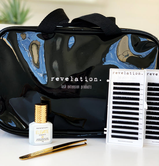 Image of Lash Carry bag, Elevate glue, and 2 of the 4 lash trays that come with the Eyelash Extension Kit to show the size of the bag.