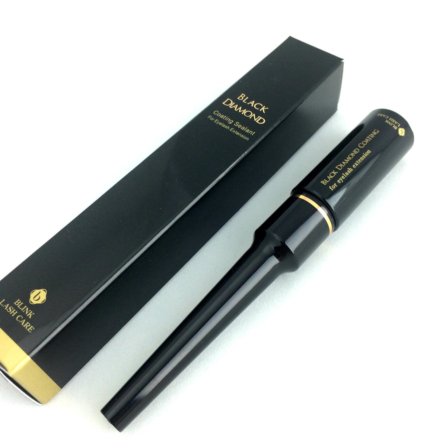 Picture of the packaging and actual bottle of Blink Black Diamond Eyelash Extension Sealant. Black with Gold Lettering