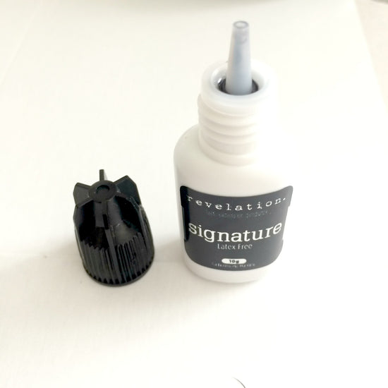 image of Signature Latex Free Eyelash Extension Glue standing up with lid off