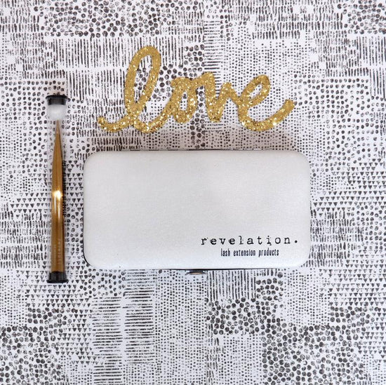 Load image into Gallery viewer, Decorative magnetic lash case closed with gold tweezers beside it and the word &amp;quot;love&amp;quot; above in cursive.
